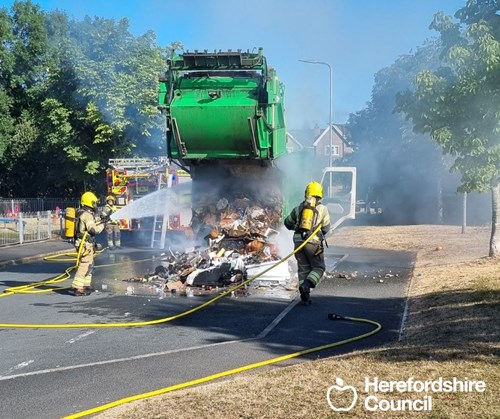 Firefighters putting out a blaze in a Herefordshire bin lorry on a public road caused by lithium iron batteries