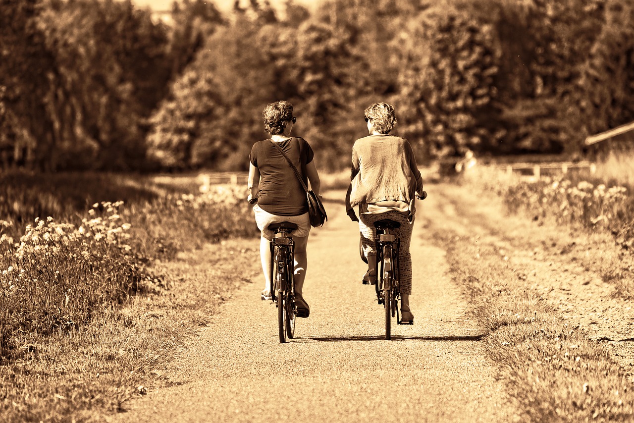 A photo of two women cycling together