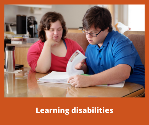 Two people with learning disabilities looking through paperwork