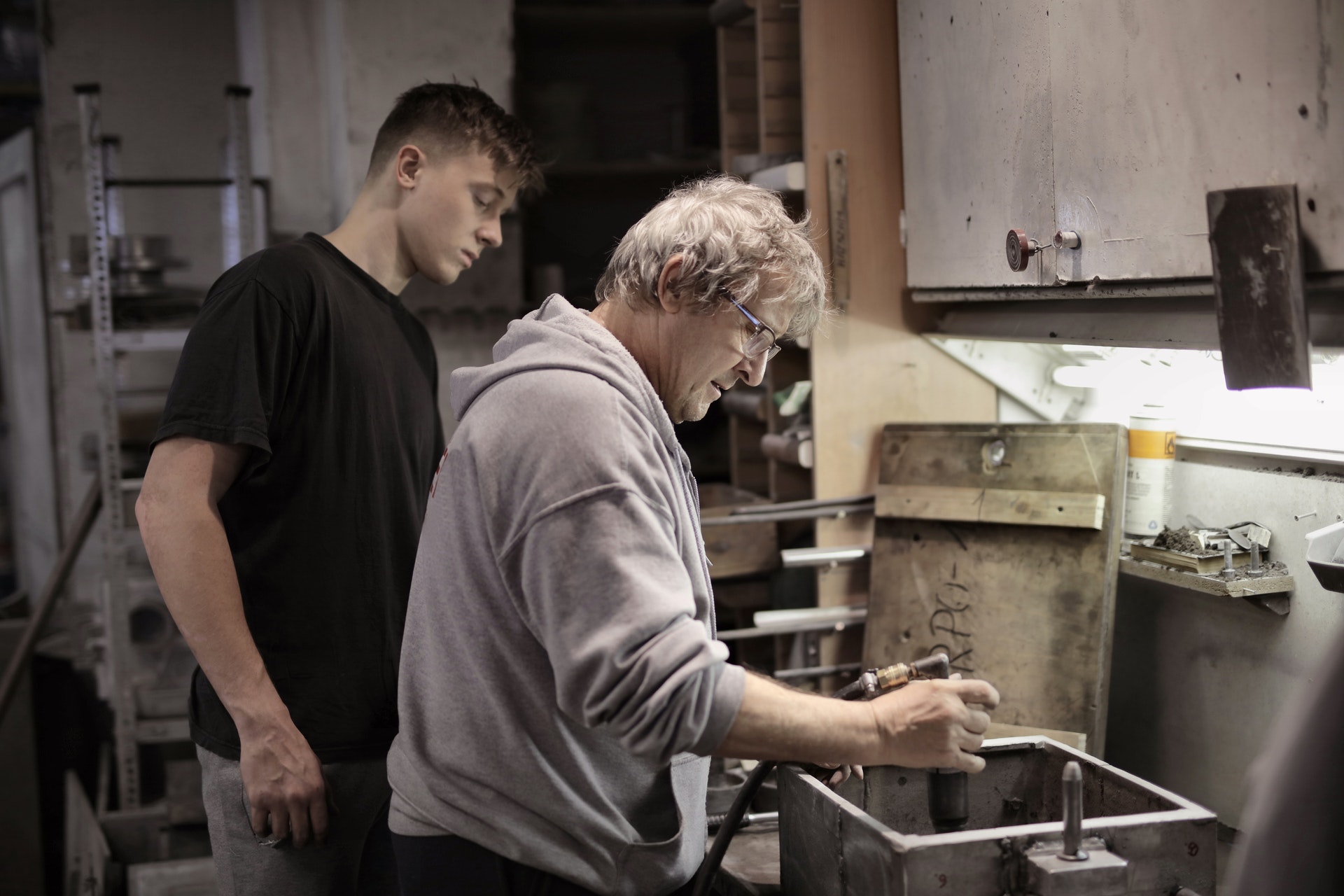An apprentice and his tutor in a workshop