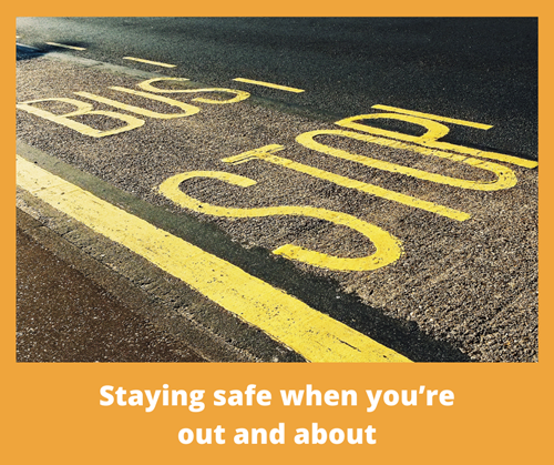 Yellow painted words on the ground, which say bus stop with the title staying safe when you’re out and about