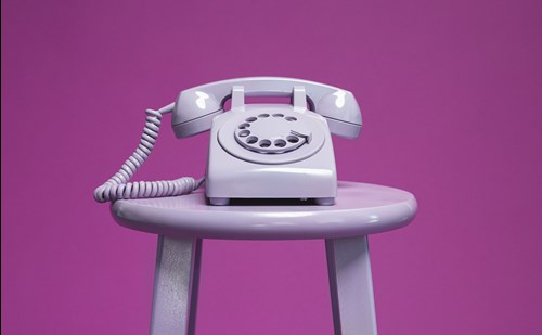analogue phone sat on table