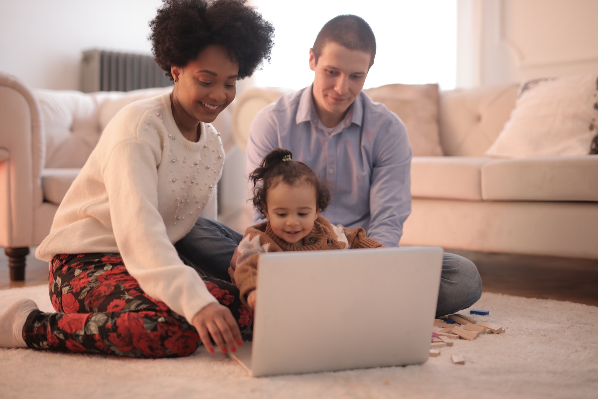 A family playing on a laptop together