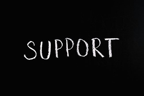 A black image containing the word support written in white