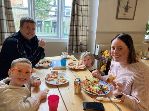 Family enjoying homemade pizza at Lion cafe as part of WoW event