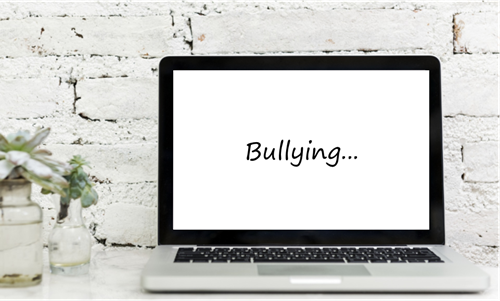 An image of a laptop with the word bullying written on its screen