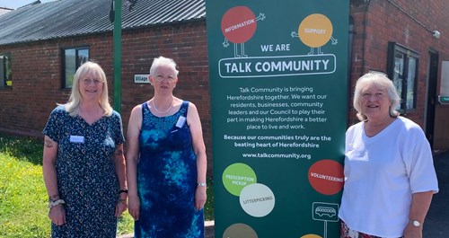 Photograph showing three volunteers from the Talk Community hub