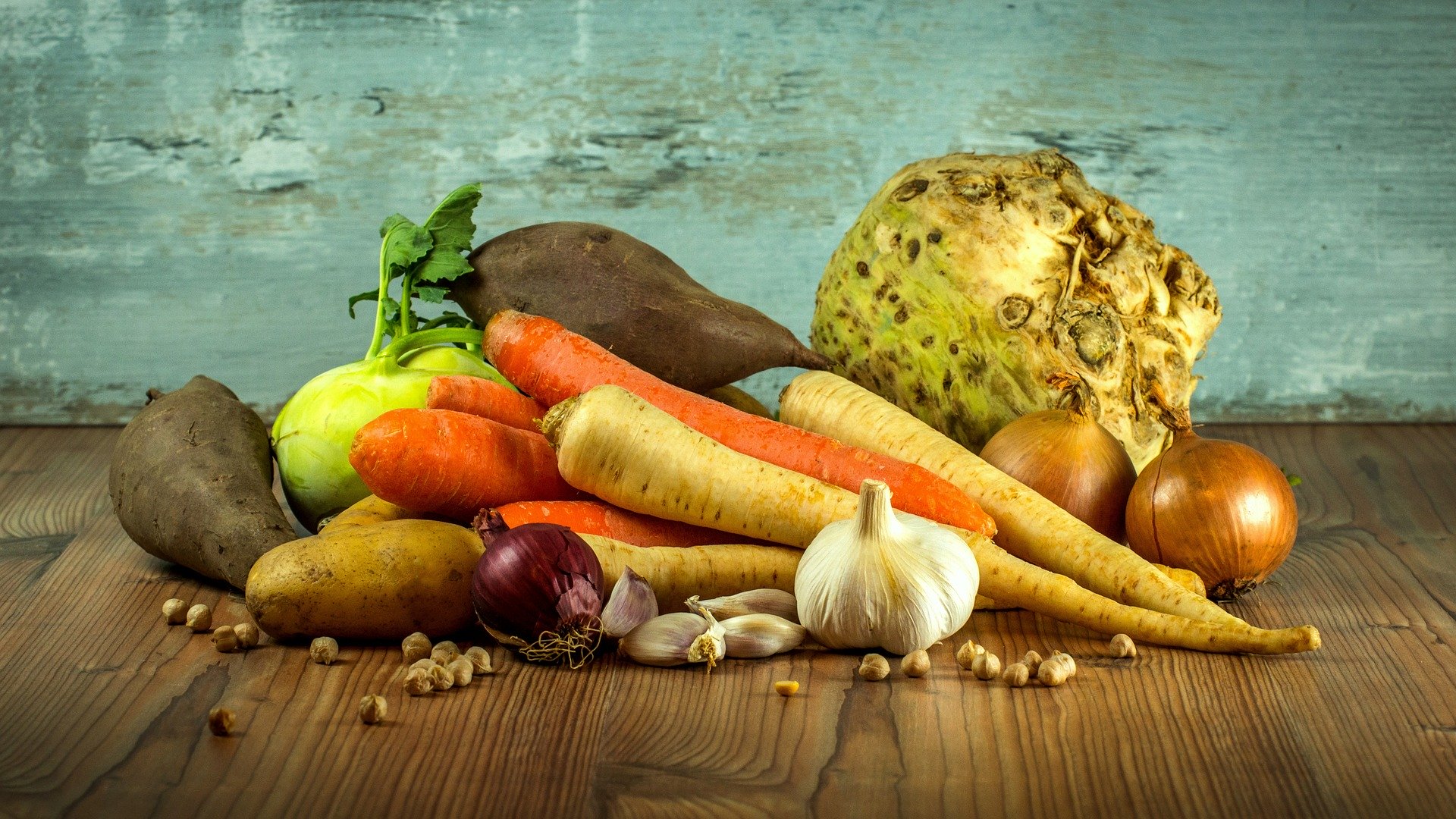 A selection of different vegetables on a wooden counter